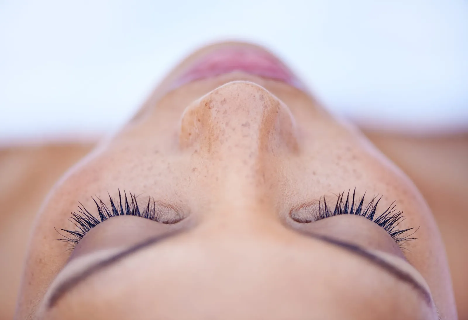 Face with closed eyes, view of the nose from below